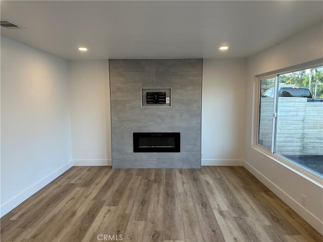 632 Truly Unit 634, Vista, CA 92084 - unfurnished living room featuring wood finished floors, a tile fireplace, and recessed lighting