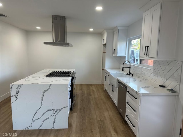 632 Truly Unit 634, Vista, CA 92084 - kitchen featuring wall chimney exhaust hood, stainless steel appliances, light stone countertops, wood finished floors, and recessed lighting