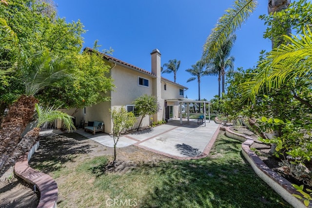 5035 Via Donaldo, Yorba Linda, CA 92886 - rear view of property featuring stucco siding, a patio area, a chimney, and a pergola