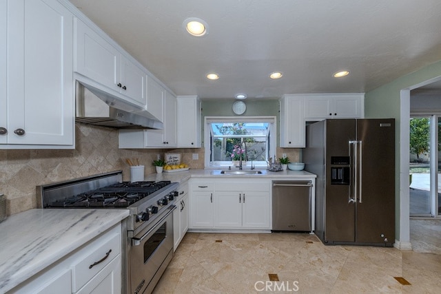 5035 Via Donaldo, Yorba Linda, CA 92886 - kitchen featuring premium appliances, under cabinet range hood, white cabinets, backsplash, and healthy amount of natural light