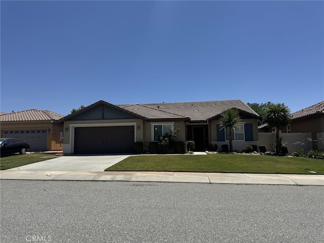 1358 Clover Way, Beaumont, CA 92223 - ranch-style home with a front yard, driveway, an attached garage, a tiled roof, and stucco siding