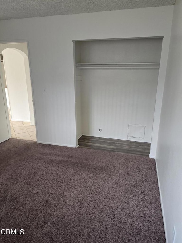 2573 Tiller Ave, Port Hueneme, CA 93041 - unfurnished bedroom featuring carpet flooring, a closet, a textured ceiling, and arched walkways