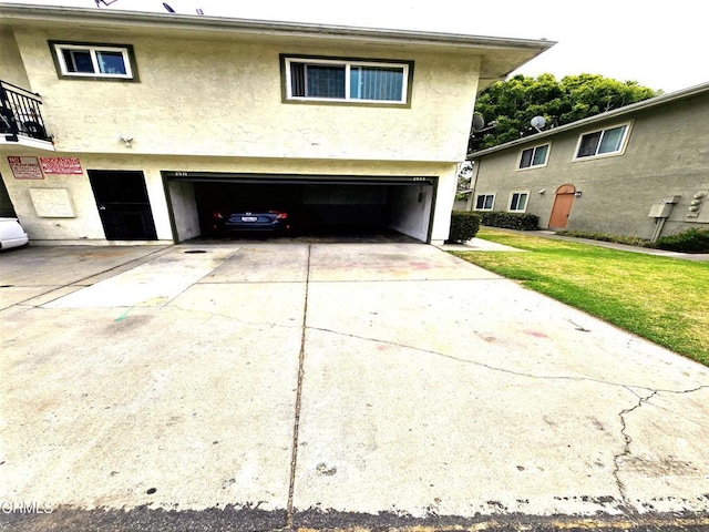 2573 Tiller Ave, Port Hueneme, CA 93041 - back of property with an attached garage, stucco siding, concrete driveway, and a yard