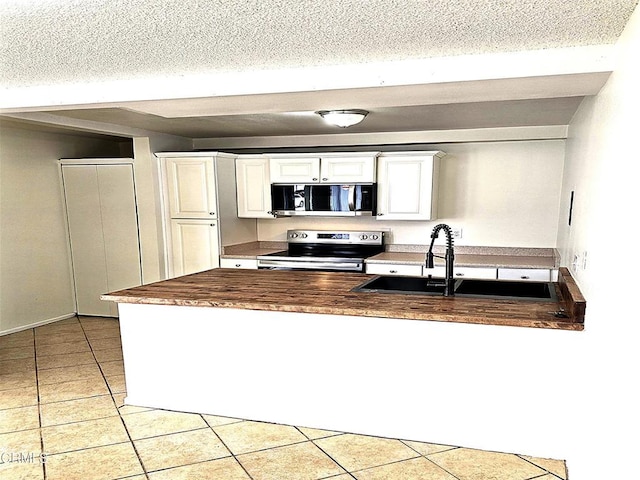 2573 Tiller Ave, Port Hueneme, CA 93041 - kitchen with appliances with stainless steel finishes, light tile patterned floors, white cabinetry, and a textured ceiling