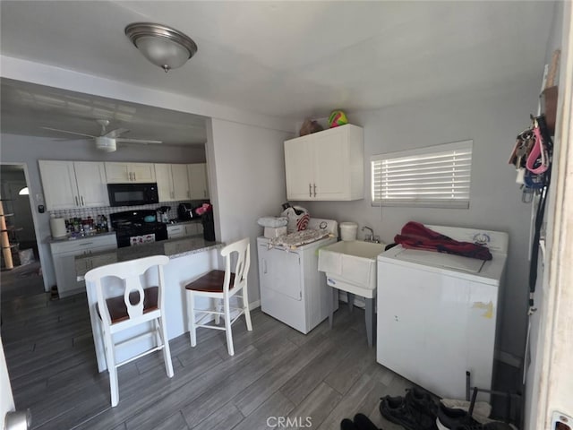3424 E Cesar E Chavez Ave, Los Angeles, CA 90063 - laundry room featuring washing machine and dryer, dark wood-style flooring, and a ceiling fan