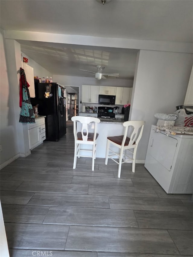 3424 E Cesar E Chavez Ave, Los Angeles, CA 90063 - kitchen with black appliances, white cabinets, a peninsula, and wood tiled floors