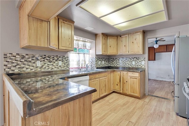 13491 Solitude Cir, Victorville, CA 92392 - kitchen with light brown cabinets, dark countertops, freestanding refrigerator, light wood finished floors, and white dishwasher