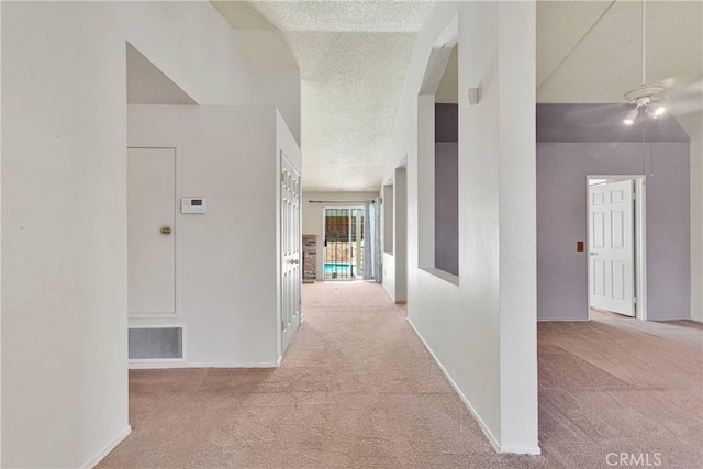 13491 Solitude Cir, Victorville, CA 92392 - hall with carpet, a textured ceiling, and vaulted ceiling