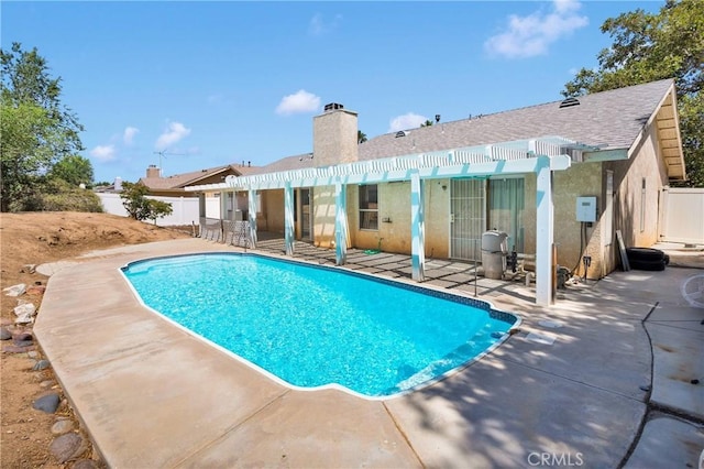 13491 Solitude Cir, Victorville, CA 92392 - rear view of house featuring a patio, a chimney, stucco siding, and a shingled roof