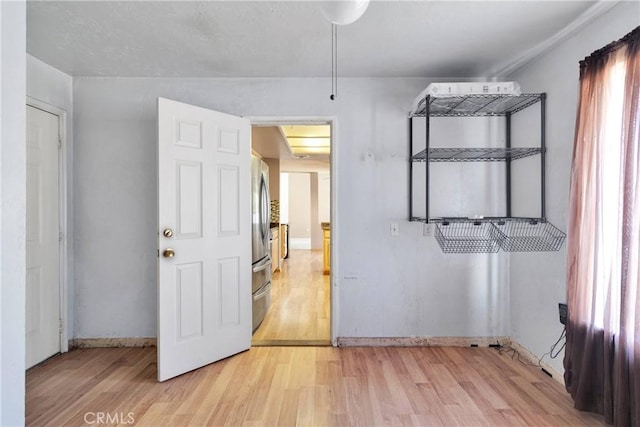 13491 Solitude Cir, Victorville, CA 92392 - unfurnished bedroom with light wood-style floors and freestanding refrigerator