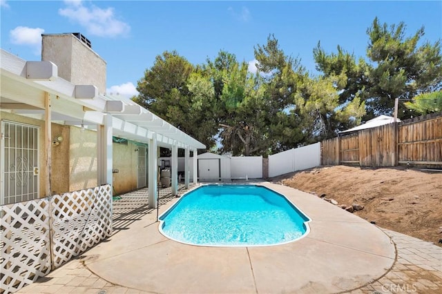 13491 Solitude Cir, Victorville, CA 92392 - view of swimming pool featuring a fenced backyard, a patio area, a storage unit, and a pergola