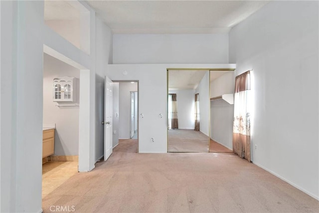 13491 Solitude Cir, Victorville, CA 92392 - unfurnished bedroom with light carpet, a closet, and a high ceiling