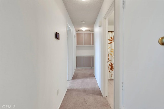 13491 Solitude Cir, Victorville, CA 92392 - hallway with light colored carpet and a textured ceiling