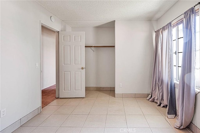 13491 Solitude Cir, Victorville, CA 92392 - unfurnished bedroom featuring a textured ceiling, light tile patterned flooring, and a closet