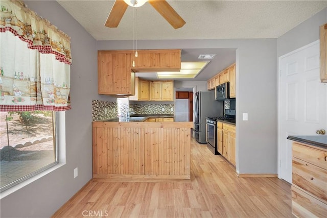 13491 Solitude Cir, Victorville, CA 92392 - kitchen with appliances with stainless steel finishes, light wood-style flooring, decorative backsplash, and dark countertops