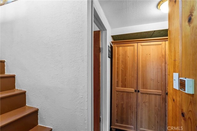 22490 Rockwell Rd, Cedarpines Park, CA 92322 - stairs featuring a textured wall and a textured ceiling