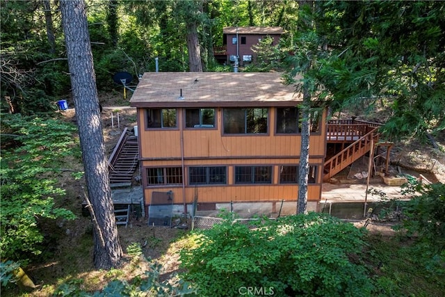 22490 Rockwell Rd, Cedarpines Park, CA 92322 - rear view of house with stairs, a wooden deck, and crawl space
