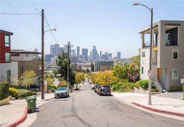 1029 White Knoll Dr, Los Angeles, CA 90012 - view of asphalt road featuring sidewalks, curbs, street lights, and a view of skyline