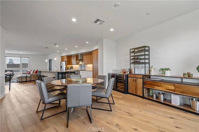 1029 White Knoll Dr, Los Angeles, CA 90012 - dining room with a dry bar, light wood-style flooring, wine cooler, and recessed lighting