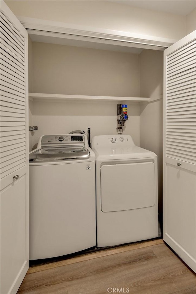 13078 Mindanao Way Unit 211, Marina Del Rey, CA 90292 - washroom featuring washer and clothes dryer and light wood-style floors
