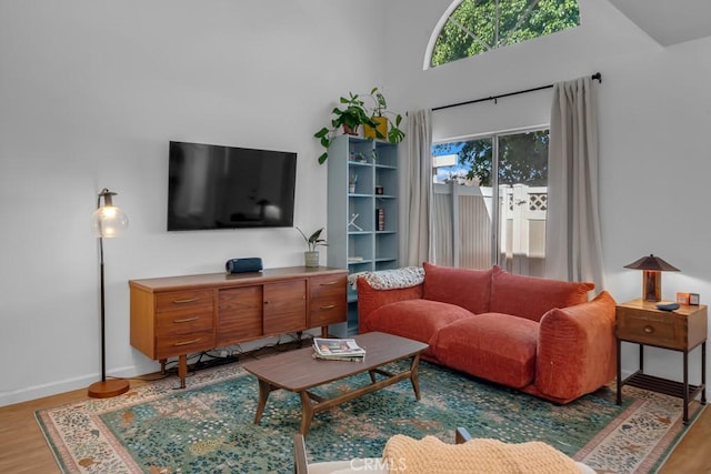 8939 Gallatin Rd Unit 116, Pico Rivera, CA 90660 - living room with light wood-style floors and a towering ceiling