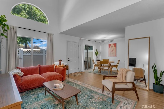 8939 Gallatin Rd Unit 116, Pico Rivera, CA 90660 - living room featuring light wood-type flooring, plenty of natural light, and a chandelier