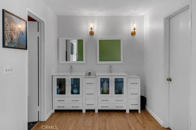 8939 Gallatin Rd Unit 116, Pico Rivera, CA 90660 - bathroom featuring wood finished floors and double vanity