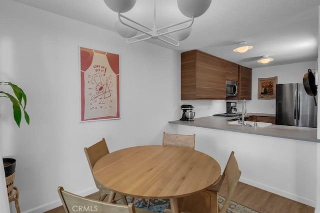 8939 Gallatin Rd Unit 116, Pico Rivera, CA 90660 - dining space featuring baseboards and wood finished floors
