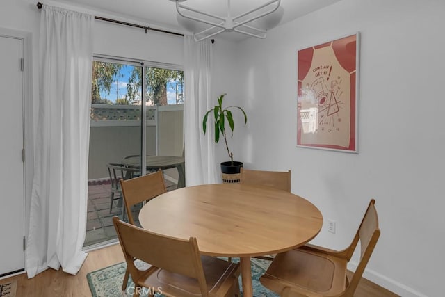 8939 Gallatin Rd Unit 116, Pico Rivera, CA 90660 - dining area featuring light wood finished floors and baseboards