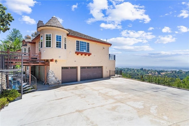 918 Reposado Dr, La Habra Heights, CA 90631 - view of front of house featuring stucco siding, an attached garage, a chimney, driveway, and stairs