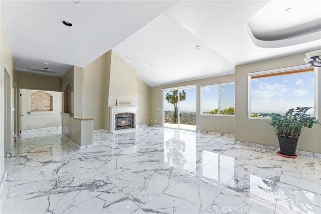 918 Reposado Dr, La Habra Heights, CA 90631 - unfurnished living room featuring marble tiled floors, a towering ceiling, a large fireplace, and arched walkways