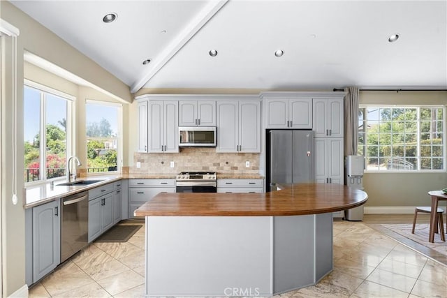 918 Reposado Dr, La Habra Heights, CA 90631 - kitchen featuring light marble finish floors, gray cabinetry, wooden counters, vaulted ceiling, and stainless steel appliances