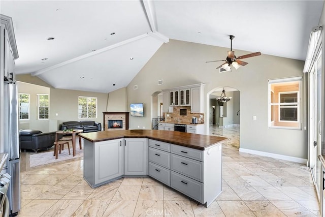 918 Reposado Dr, La Habra Heights, CA 90631 - kitchen with arched walkways, wood counters, open floor plan, gray cabinets, and ceiling fan