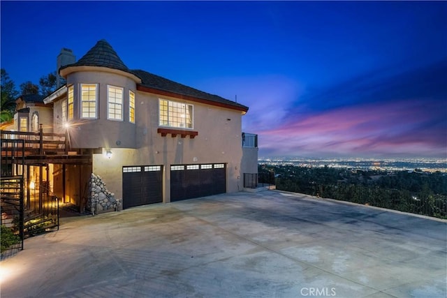 918 Reposado Dr, La Habra Heights, CA 90631 - view of side of property with stucco siding, a garage, a chimney, and concrete driveway