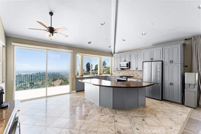 918 Reposado Dr, La Habra Heights, CA 90631 - kitchen featuring gray cabinets, stainless steel appliances, backsplash, a ceiling fan, and vaulted ceiling