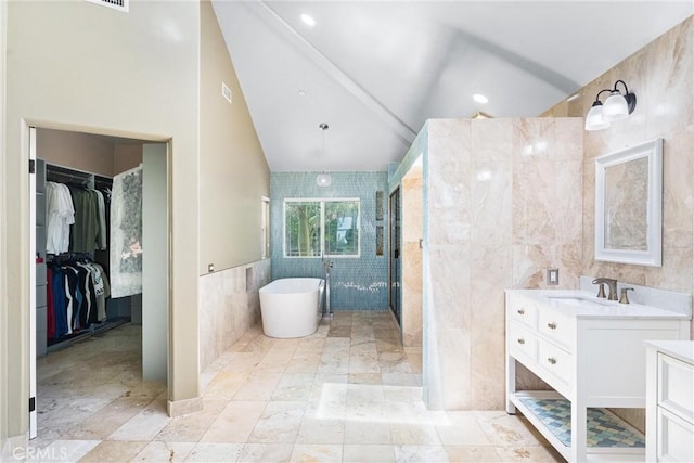 918 Reposado Dr, La Habra Heights, CA 90631 - full bathroom featuring tile walls, vanity, a freestanding bath, a spacious closet, and lofted ceiling