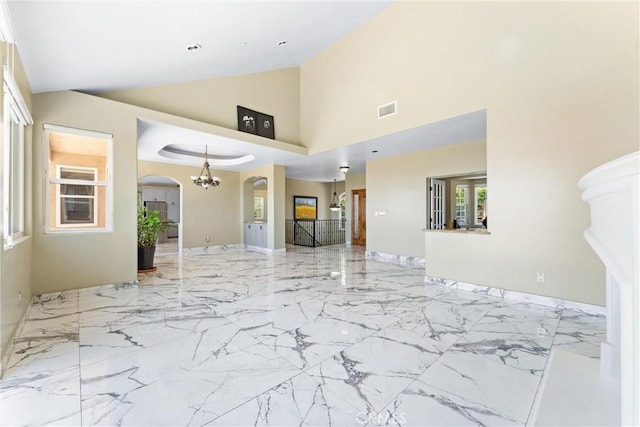 918 Reposado Dr, La Habra Heights, CA 90631 - unfurnished living room featuring arched walkways, high vaulted ceiling, marble finish floors, and a chandelier
