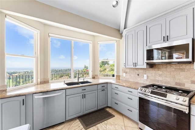 918 Reposado Dr, La Habra Heights, CA 90631 - kitchen featuring stainless steel appliances, plenty of natural light, light stone counters, and decorative backsplash