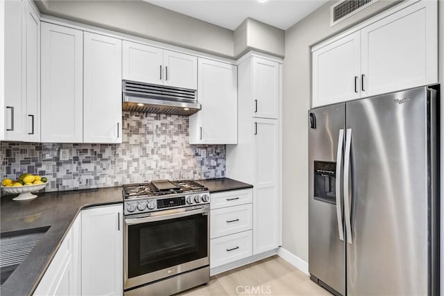 29 Hinterland Way, Ladera Ranch, CA 92694 - kitchen featuring stainless steel appliances, custom range hood, dark countertops, light wood finished floors, and white cabinetry