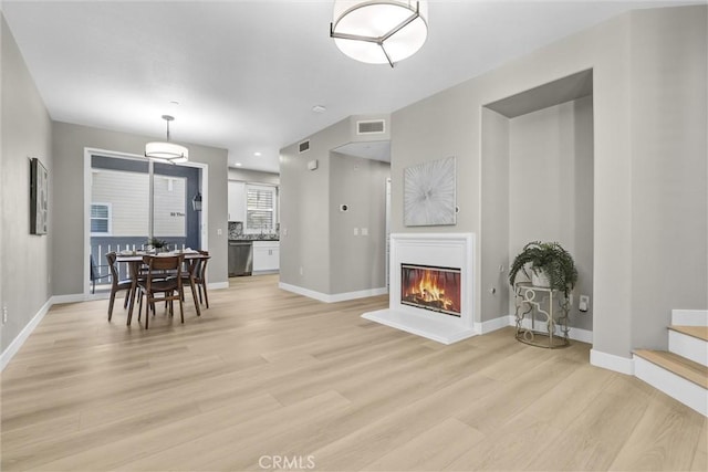 29 Hinterland Way, Ladera Ranch, CA 92694 - living room with light wood finished floors and a glass covered fireplace