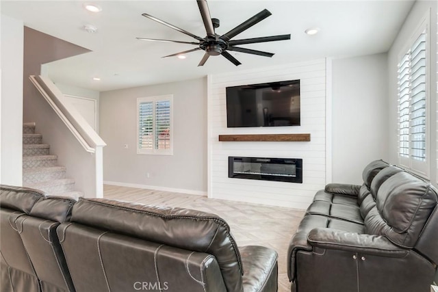 4989 River Ash Way, Fontana, CA 92336 - living room with ceiling fan, healthy amount of natural light, recessed lighting, stairway, and a large fireplace