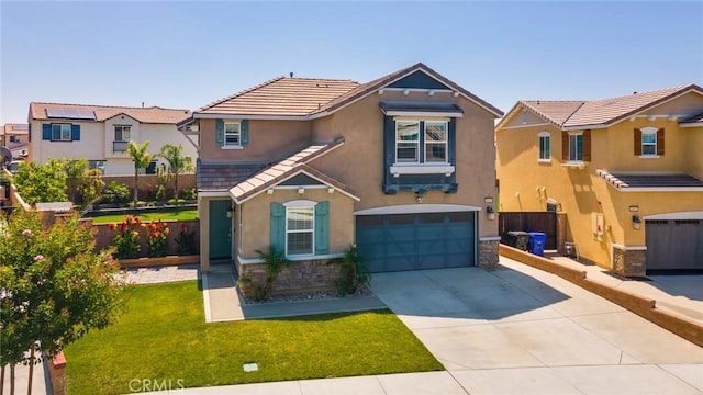 4989 River Ash Way, Fontana, CA 92336 - view of front of property with stone siding, a garage, stucco siding, and driveway