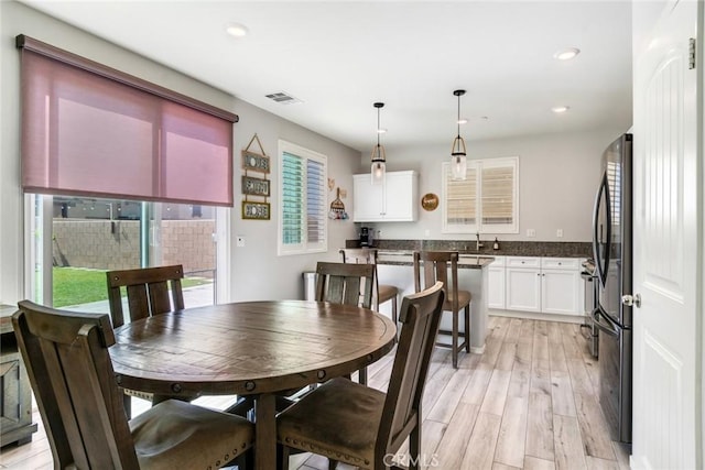 4989 River Ash Way, Fontana, CA 92336 - dining space with light wood-style flooring and recessed lighting