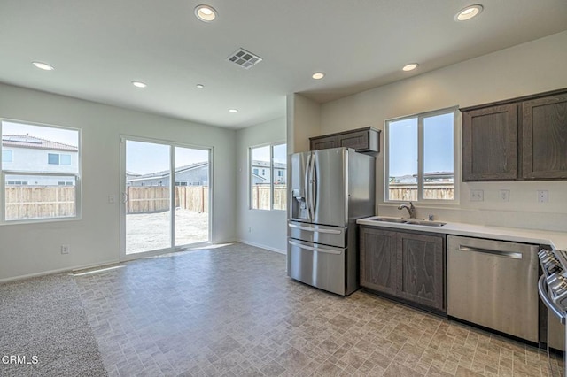 3016 Via Bella Rosa Ave, Rosamond, CA 93560 - kitchen featuring stainless steel appliances, recessed lighting, dark brown cabinets, light countertops, and open floor plan