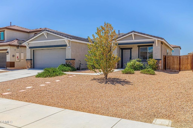 3016 Via Bella Rosa Ave, Rosamond, CA 93560 - view of front facade featuring concrete driveway, an attached garage, stone siding, and stucco siding