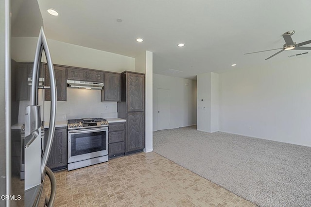 3016 Via Bella Rosa Ave, Rosamond, CA 93560 - kitchen with appliances with stainless steel finishes, under cabinet range hood, dark brown cabinets, a ceiling fan, and recessed lighting
