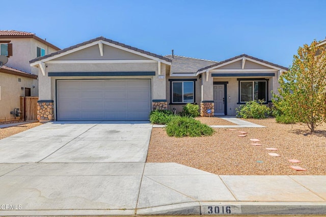 3016 Via Bella Rosa Ave, Rosamond, CA 93560 - view of front facade featuring a tiled roof, a garage, concrete driveway, stucco siding, and stone siding