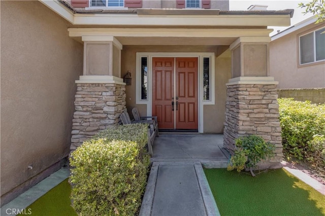 6219 S Kingsmill Ct, Fontana, CA 92336 - doorway to property with stucco siding and stone siding