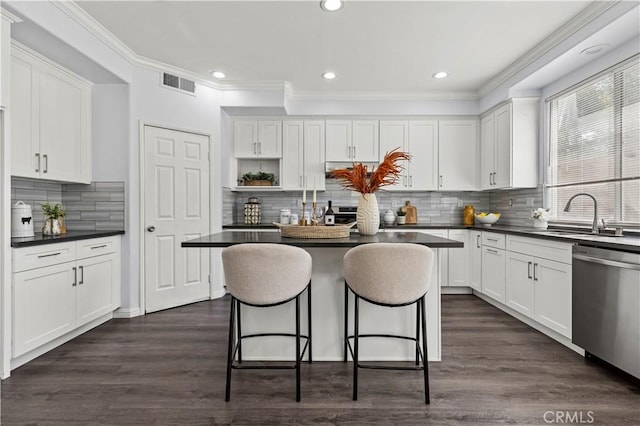 6219 S Kingsmill Ct, Fontana, CA 92336 - kitchen featuring stainless steel dishwasher, dark countertops, white cabinets, crown molding, and recessed lighting