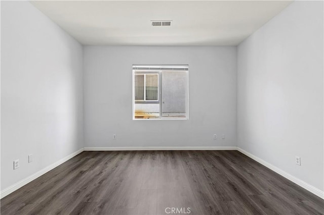 6219 S Kingsmill Ct, Fontana, CA 92336 - spare room featuring dark wood-style floors and baseboards